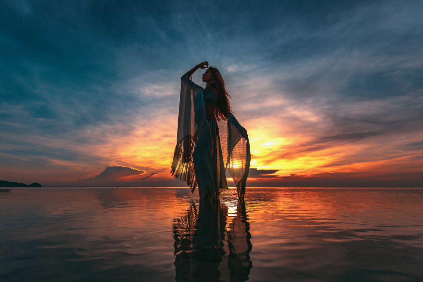 Empowered woman standing in the ocean