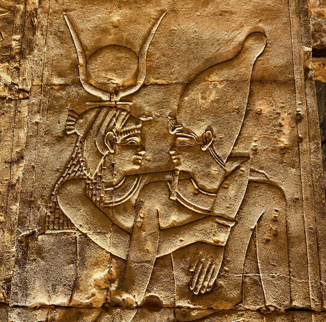 Ancient Egyptian temple relief of Isis and Osiris
